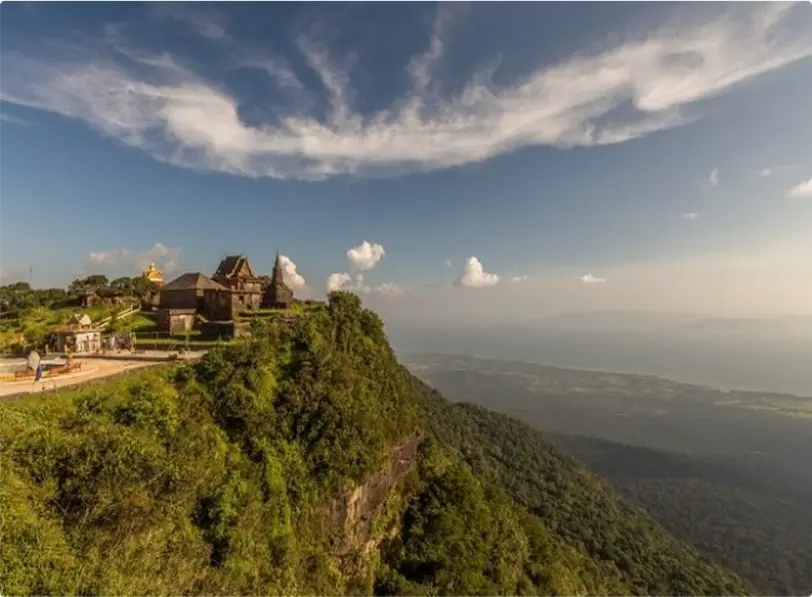 Scenic view of Bokor Mountain with a historic temple on the cliff and panoramic landscape below.